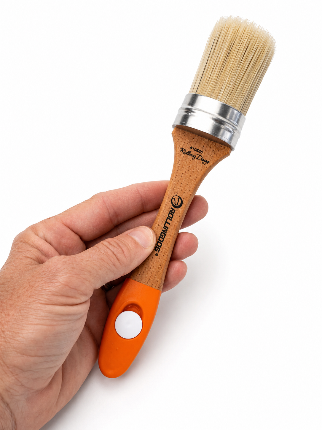 Hand holding an oval chalk brush